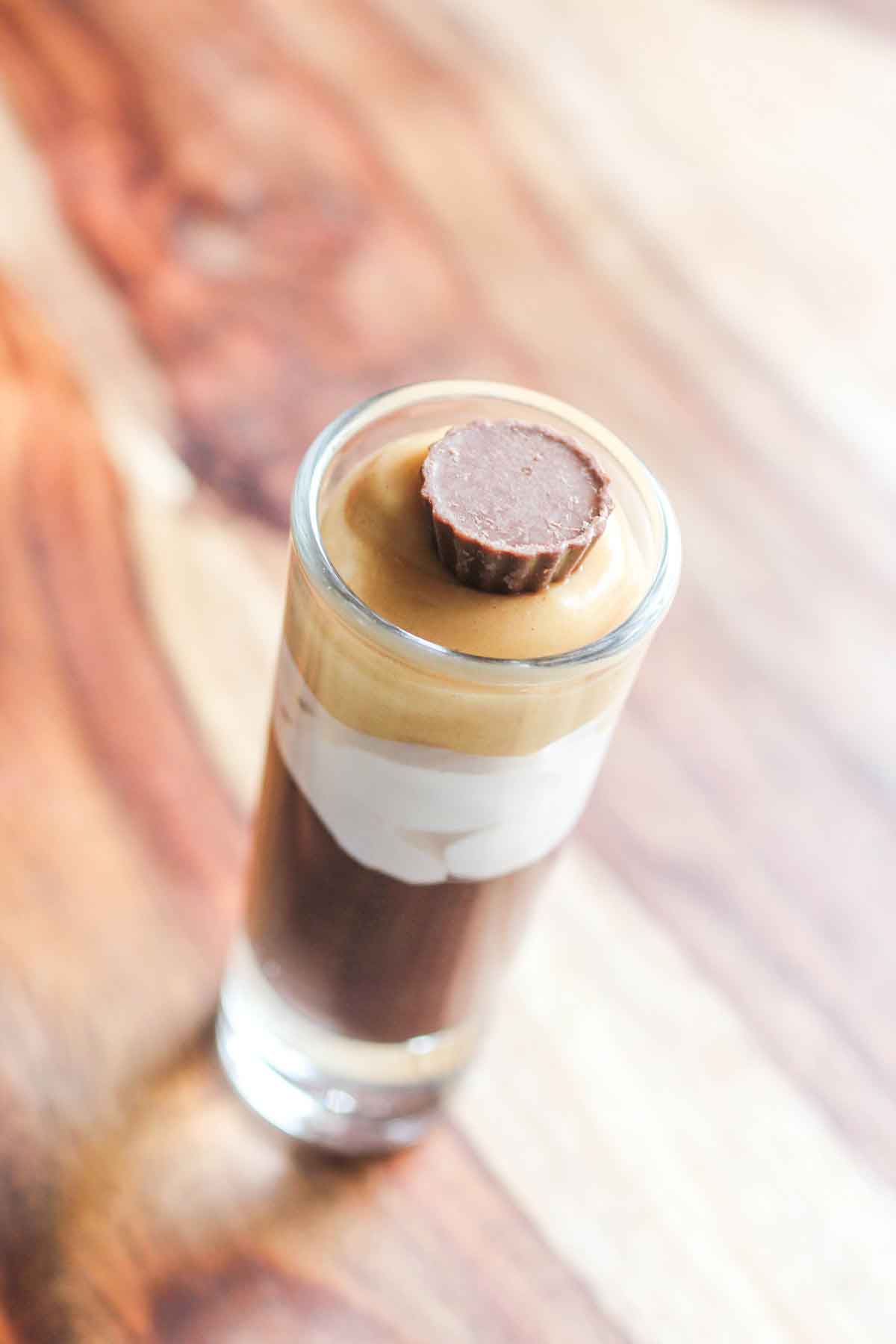 A glass full of chocolate peanut butter parfait