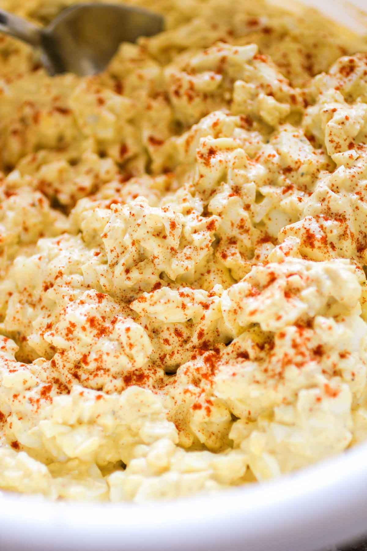 Best Egg Salad in a large white bowl with a spoon