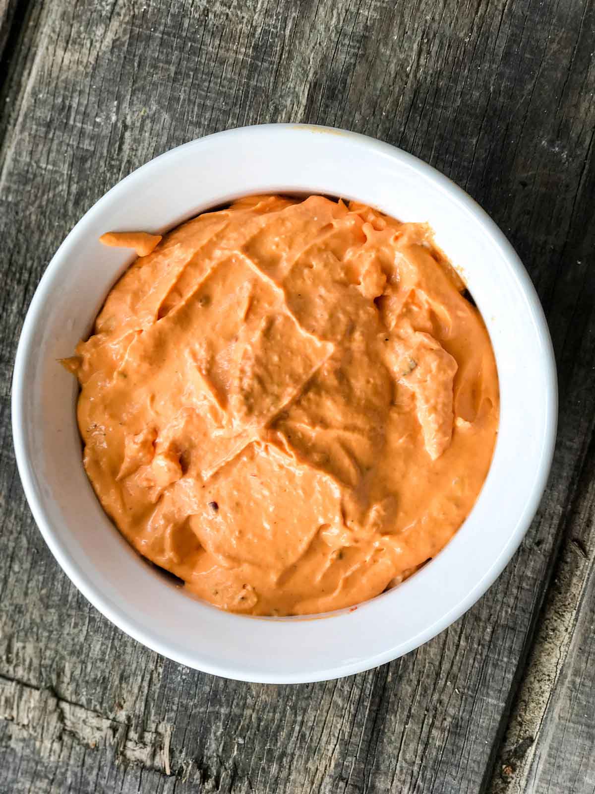 Close up of a Roasted Red Pepper and Feta Dip in a White Bowl