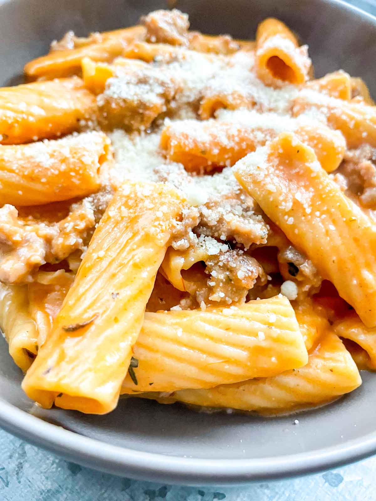 extreme close up of pizza pasta with parmesan cheese sprinkled on top