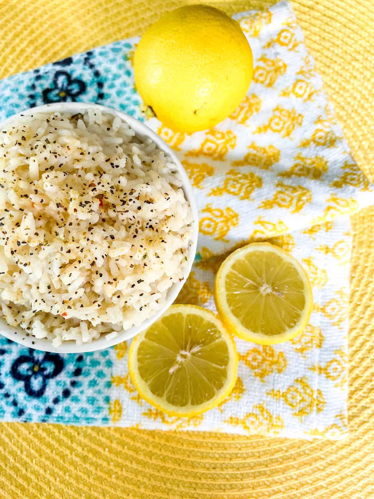 Bowl of Rice surrounded by lemons.