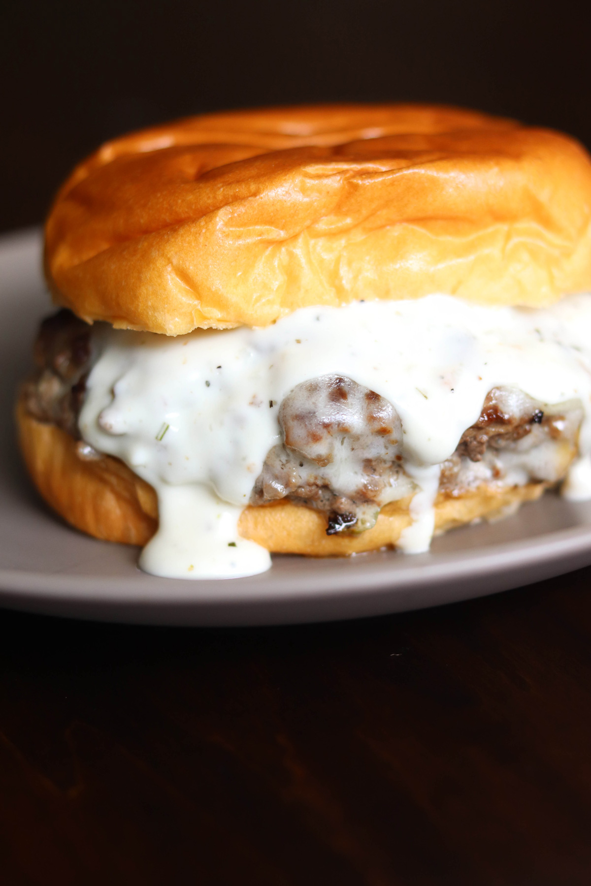 Garlic Overload Burgers with Creamy Garlic Burger Sauce Dripping Down