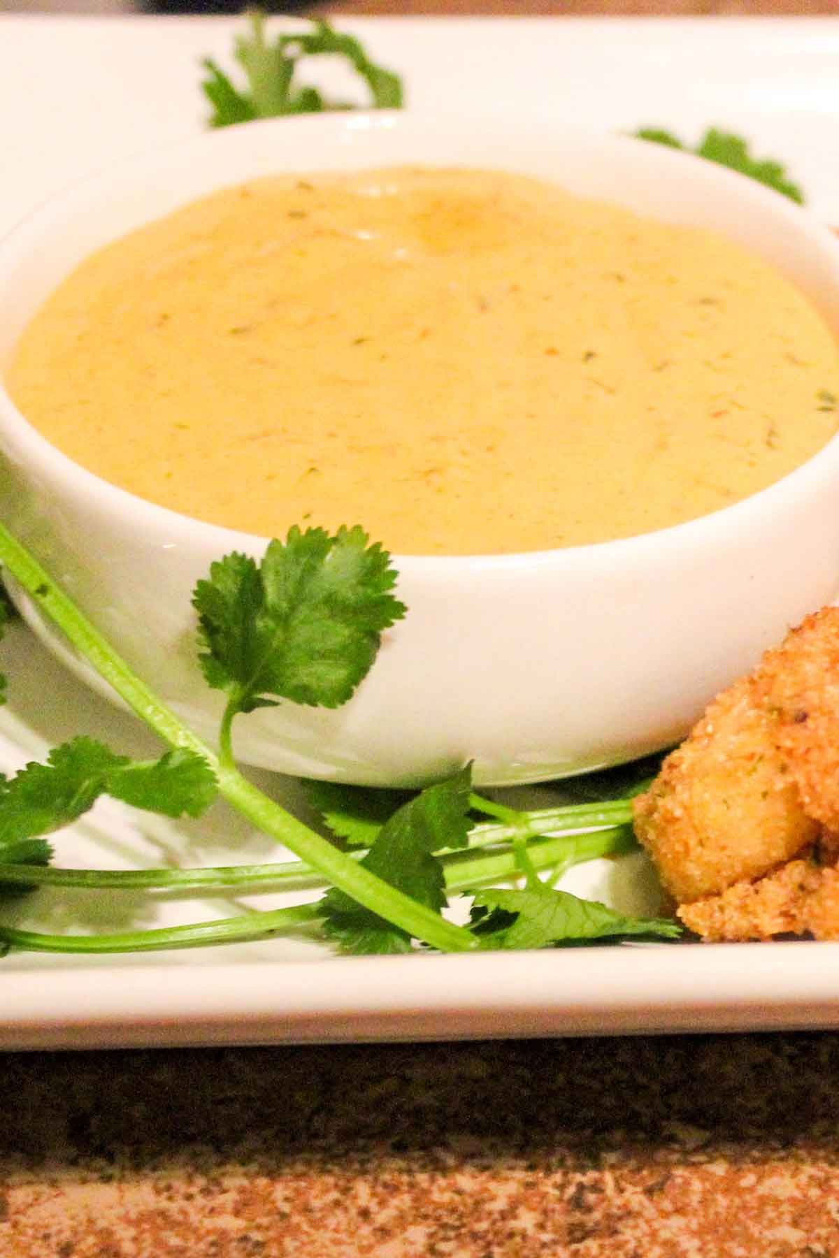 Spicy Ranch Dip in a white bowl with cilantro garnish